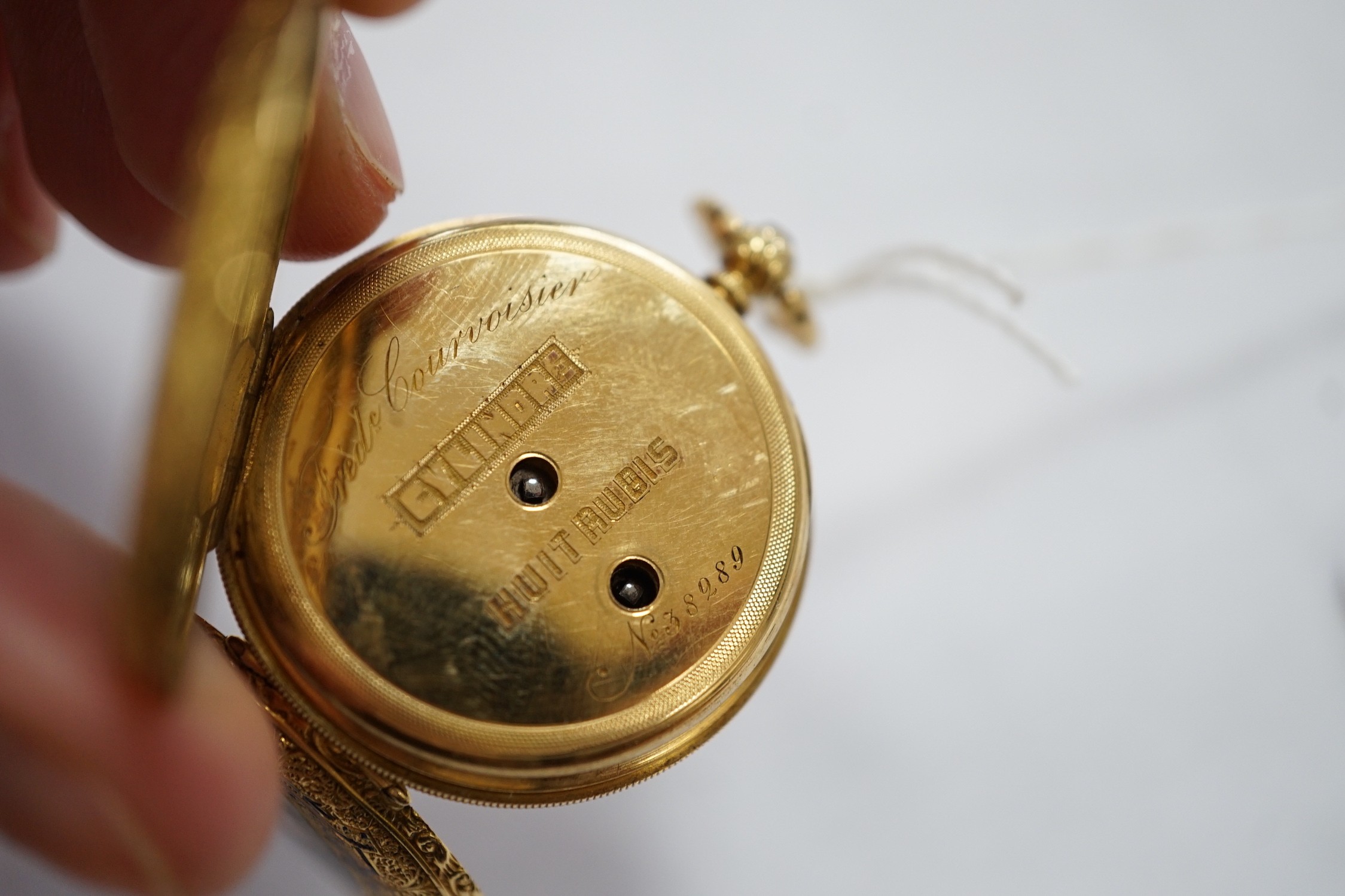 An early 20th century Swiss 18k and enamelled fob watch, decorated with the bust of a young girl and flowers verso, case diameter 33mm, gross weight 27.3 grams.